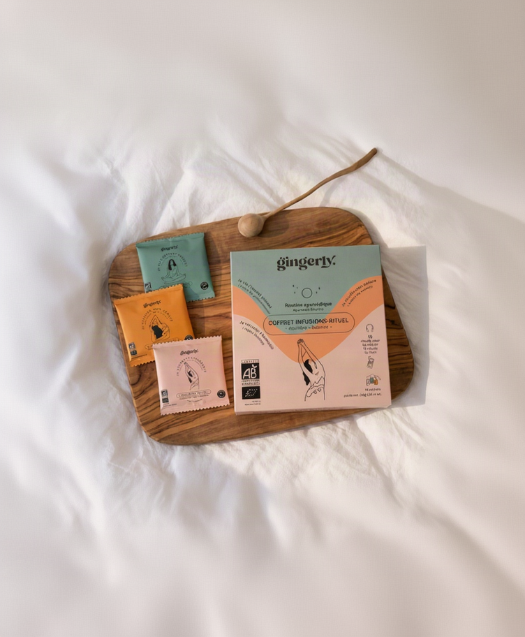 Coffret cadeau tisanes bio Gingerly Équilibre et ses trois recettes sur un plateau noir