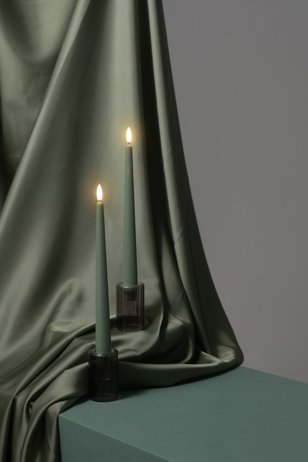 Bougies fines LED effet soie vert mousse, dans un chandelier